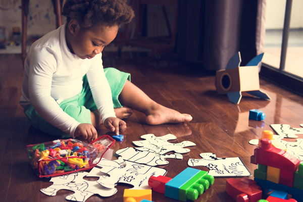 Child playing with puzzles and letters